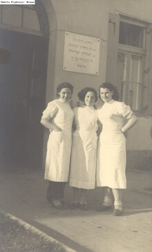 Nurses at the entrance to a building of the pioneering training program (hachshara) of the He-Chaluts movement in Grochow1937-38.